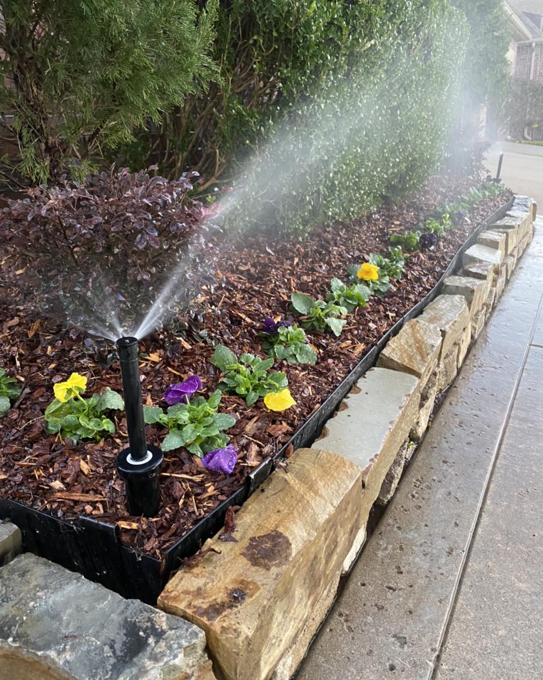 Broken Arrow Sprinkler System repaired for a garden bed with mulching and flowers